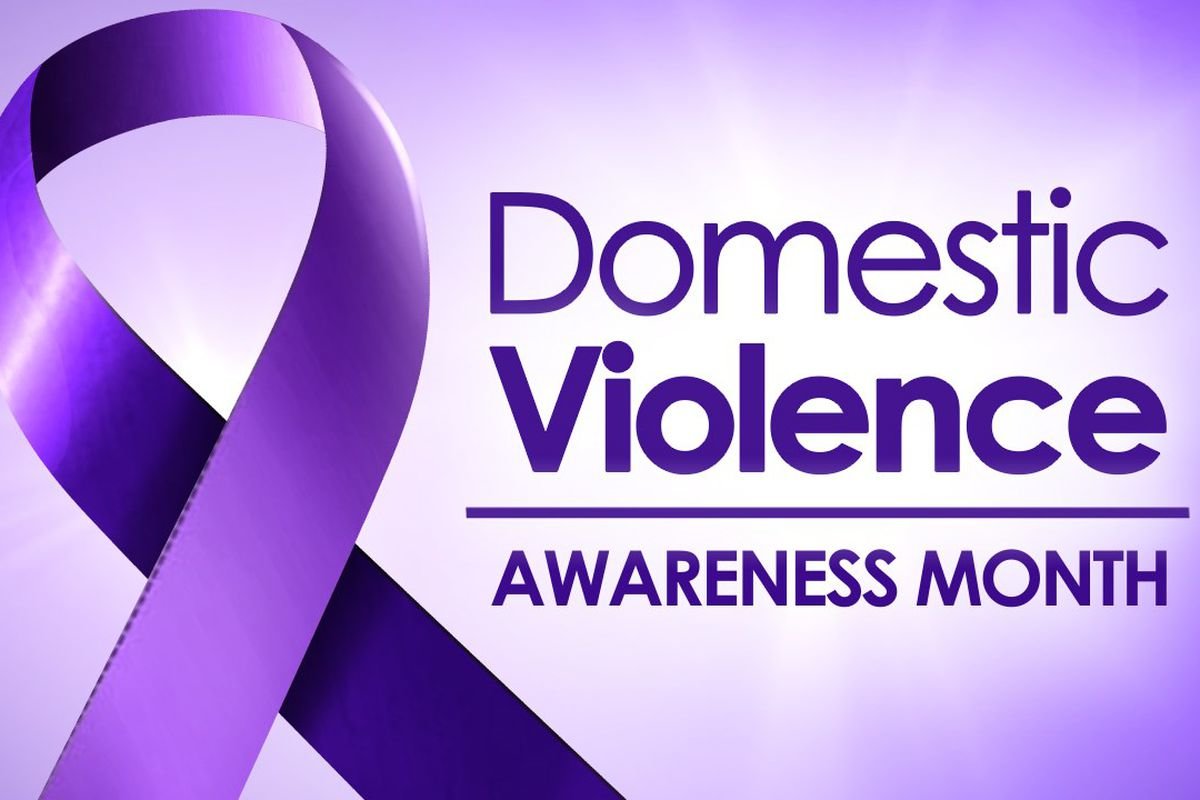 Purple ribbon to symbolize Domestic Violence awaareness. Text that reads Domestic Violence Awareness Month. Image from kempercountymessenger.com|