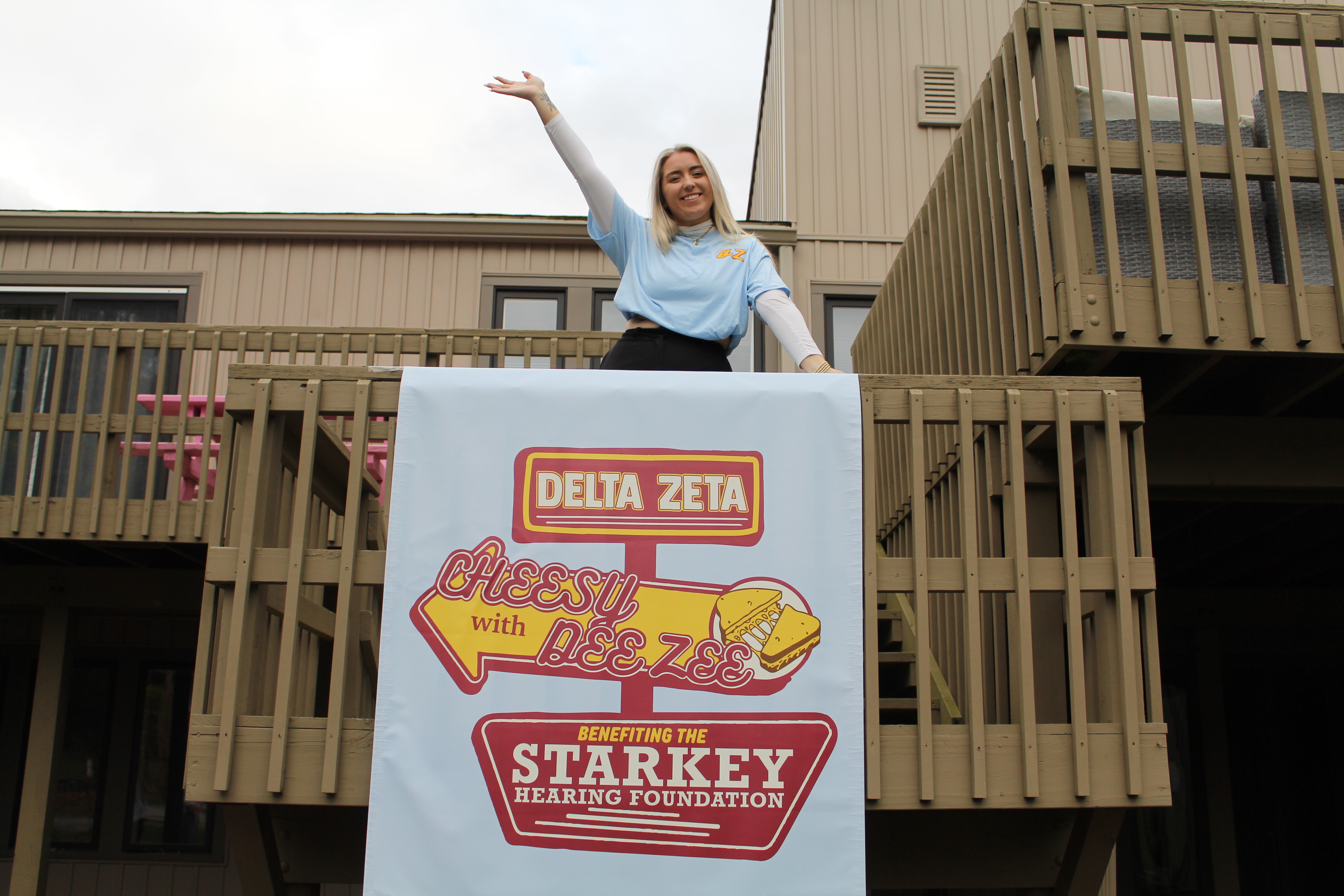 Picture of Hannah Puccini posing on a deck while standing above the 