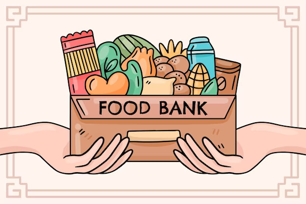 Two hands holding a box that says 'food bank' on it filled with different foods ranging from carrots, potatoes, and lettuce. Other miscellaneous foods are included as well in the background.